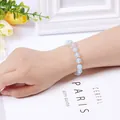 Elegant beaded bracelet with light blue translucent crystals and silver metal spacers - Opal Bracelet (Silver Color)
