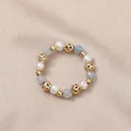 Elastic ring featuring genuine freshwater pearls, light blue stones and gold beads - Artificial Pearl (Aquamarine)