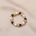 Elastic freshwater pearl ring with black beads and gold hollow metal accents - Artificial Pearl (Black Spinel)