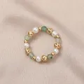 Elegant elastic freshwater pearl ring featuring green gemstones and hollow gold beads. - Artificial Pearl (Green Aventurine)