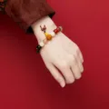 Hand wearing an 18-bead traditional Chinese sandalwood and multi-stone bracelet - New 3rd Gen 18 Seeds