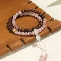 Elegantes zweischleifiges Armband mit rosa Katzenaugensteinen und dunklem Sandelholz - Goldenes Sandelholz Rosa Katzenauge