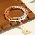 Pulsera de doble capa con cuentas de ojo de gato y madera en tonos cálidos. - Ojo de Gato Naranja y Blanco