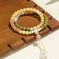 Pulsera de doble hilo de cuentas de colores con amuleto de hebilla de la paz. - Ojo de Gato Blanco Alashan Semilla de Bodhi