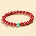 Elegant red cinnabar bead bracelet featuring a single turquoise accent stone for women - 6mm Cinnabar Red With Turquoise