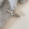 Detail of silver minimalist hair clip featuring heart bow and 'Hand made' engraving. - Heart Bow (Oval Clip) / Silver