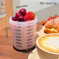 Portable pink plastic fruit salad cup with drainer for outdoor picnic use, 12cm height. - Pink
