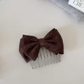 Detail view of a stylish brown polka dot bow hair comb with elegant silver metal teeth. - Double Layer Bow Insert Comb / Coffee Polka Dot