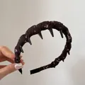Detailed view of vintage floral fabric wrapped headband with black spikes - Comb Style / Dark Coffee Floral