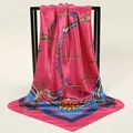 Close-up of luxurious pink satin square scarf featuring elegant chain and horsebit patterns - 90x90cm / Rose Red