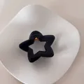 Detalle de una pinza para el pelo minimalista con forma de estrella azul en un plato blanco - Estrella Plateada / Azul marino