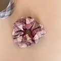 Detail view of a purple and beige plaid scrunchie with soft fabric texture - Scrunchie / Pink Purple Plaid