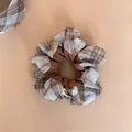 Close-up of brown plaid patchwork scrunchie with soft fabric texture - Scrunchie / Blue and Brown Plaid