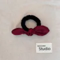 Detail showing the burgundy satin bow hair scrunchie and black ribbed elastic band - Bowknot Hair Tie