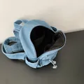 Spacious light blue denim backpack showing detailed black interior lining and pockets - Detail Display Style