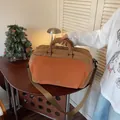 Large casual canvas travel duffle bag with shoulder strap in brown and orange tones - Brown