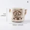 Gedetailleerd overzicht van harsbloempot met monstergezicht, 7 cm hoog en 10,8 cm breed - Demon Stijl met Slagtanden (A)