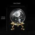 Creative laser engraved crystal ball with moon astronaut design on an ornate gold stand - Moon Landing Astronaut (Gold)