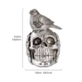Resin skull sculpture with bird detail for Halloween decor showing 14.8cm height dimensions - Crow On Skull Style (Silver Foil)