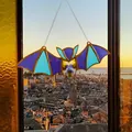 Close-up of stained glass bat pendant featuring vibrant wings and pressed flower body - Acrylic Pendant - Blue Bat