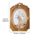 Ornate gold resin photo frame featuring vintage floral carvings and an oval center - 7" / 23.1x16.1cm