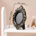 Vintage black and gold ornate embossed oval photo frame 3.14 x 4.25 inch standing on shelf - A58 Oval Style (Prop Photo Frame - Black Gold) / 8x10.8cm