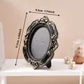 Vintage black and gold embossed oval picture frame with 4.6-inch height - 9.5x11.7cm