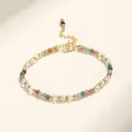 Detailed macro view of multi-color gemstone beaded bracelet with gold plated spacers - Tourmaline