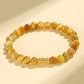 Elegantes goldenes Tigerauge-Perlenarmband mit einer traditionell gravierten Goldperle - Goldenes Tigerauge | Verheißungsvolles Glück