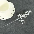 Close-up detail of white artificial berry pick stem for DIY Christmas wreath decoration - White Berry Branch / White