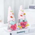 Pair of Mother's Day gnomes with pink hats holding hearts on a white book display - Mother Day Pearl Style (C2-10/11) / 2 Piece Set