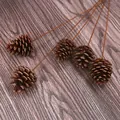 Detailed view of natural brown pinecones on long decorative stems on wood background - 3-4cm Natural Style / 40cm Length