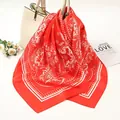 Close-up detail of a red satin square scarf featuring intricate white paisley patterns. - 90x90cm / Red (AR-2)