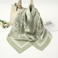 Detail of a 90cm sage green satin square scarf with elegant white paisley patterns. - 90x90cm / Pale Green (AR-8)
