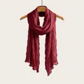 Elegant burgundy pleated cotton linen scarf draped on a wooden hanger for classic styling - Burgundy