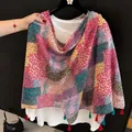 Detailed view of colorful floral patchwork scarf with red and green tassels - 180cm / Pink Patchwork