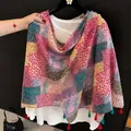 Close-up detail of a lightweight floral print shawl featuring decorative tassels - 180cm / Pink Patchwork