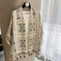 Detailed view of lightweight floral print sunscreen shawl with decorative green tassels - 180cm / Beige Green Window Grille