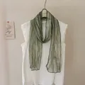 Detailed view of a green tie-dye striped long scarf featuring elegant black finished edges - 179cmx17cm / Light Green