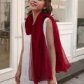 Detail of a lightweight deep red gauze scarf draped on a white dress - Long (140-180cm) / Burgundy