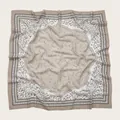 Close-up detail of a square floral print scarf featuring elegant wavy laser-cut edges. - 110X110CM / Beige Floral