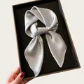 Close-up detail of smooth silver satin square scarf showing its elegant sheen and texture - 68cm / Gray