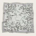 Close-up detail of a soft floral print square scarf featuring delicate wavy cut edges. - 110X110CM / Off-white Floral (Bo110cm-21#)
