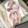 Elegant women's silk square scarf with pink belt pattern displayed on a beige blazer - 70x70cm / Pink Nautical Compass