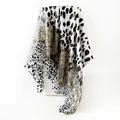 Detailed view of the leopard print satin square scarf showing its elegant silky texture - Gray