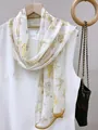 Detailed view of lightweight floral print chiffon scarf draped on white dress - 35*140cm / Lilac Stone Style