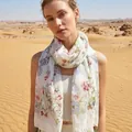 Elegant floral lightweight summer scarf for women shown in a desert setting - 180cm / Light Green Iris