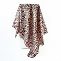 Close-up detail of a leopard print satin square scarf featuring elegant pink stripe borders - Leopard Pink