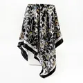 Detail view of a leopard print satin square scarf draped on a white pedestal - Black and White