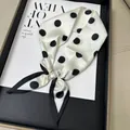 Elegant white polka dot scarf featuring a large faux pearl magnetic buckle closure - White Polka Dot